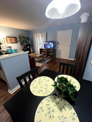 a dining room with two tables and a kitchen at Vet School - Pools Full Kitchen Queen Bed in Auburn
