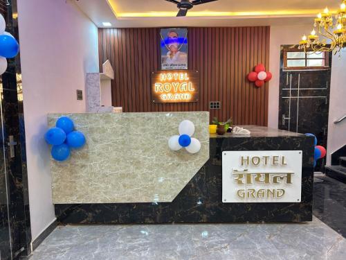 a hotel lobby with a reception desk with blue and white balloons at Hotel Royal Grand in Gomti Nagar