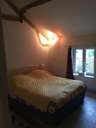 a bedroom with a bed and a window at House, pool, large garden in Orville in Orville