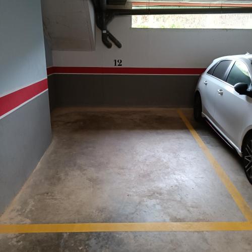 a garage with a white car parked in it at Apartamento Altafulla in Altafulla