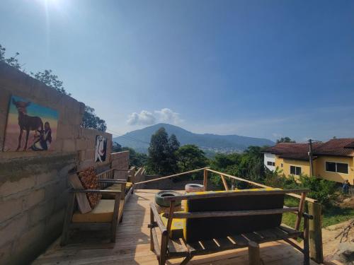 a group of benches sitting on a deck with mountains in the background at EMMY'S HIDE AWAY in Iringa