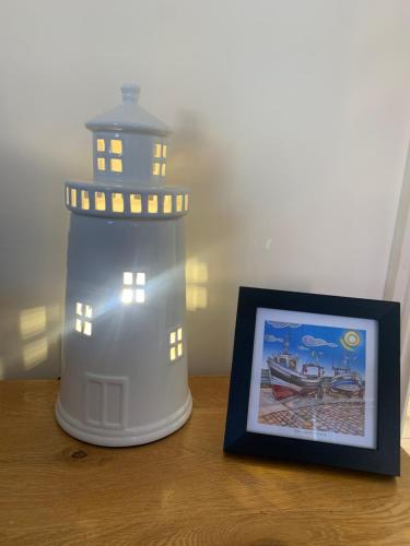 a picture of a light house on a table at Sunrise at The Bay Filey in Filey