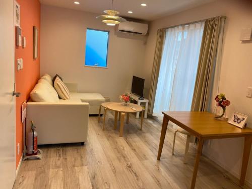 a living room with a couch and a table at Y's INN Nakai 005T in Tokyo
