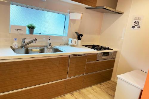 a kitchen with a sink and a window at Y's INN Nakai 005T in Tokyo