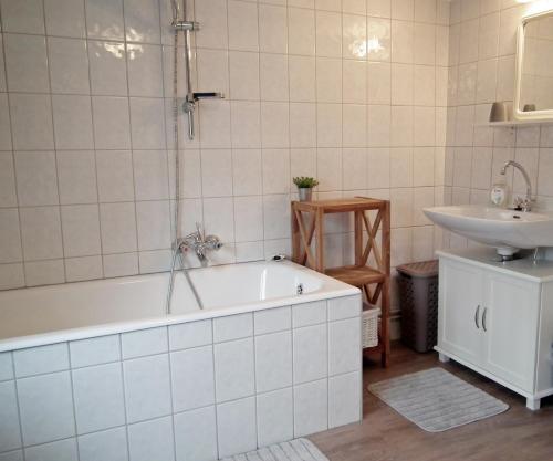 a bathroom with a tub and a sink at Carmius - Back to simple life in Burg-Reuland