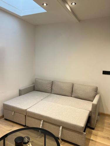 - un canapé dans une pièce avec fenêtre dans l'établissement Appartement, à Neuilly-sur-Seine