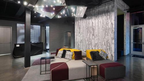 a living room with a couch and a table at Aloft Cincinnati West Chester in West Chester
