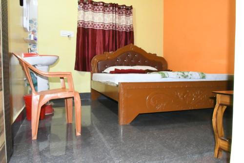 a bedroom with a bed and a desk and a chair at PR Plaza in Konārka