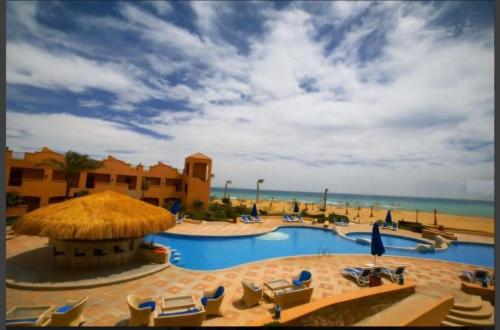 a resort with a swimming pool and a beach at La Rosa Empire Hotel-Ain Sokhna in As Suways