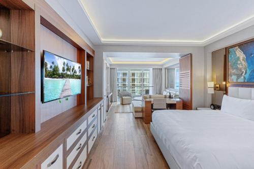 a hotel room with a bed and a desk at Stylish Oceanview Apartment Prime Location in Fort Lauderdale