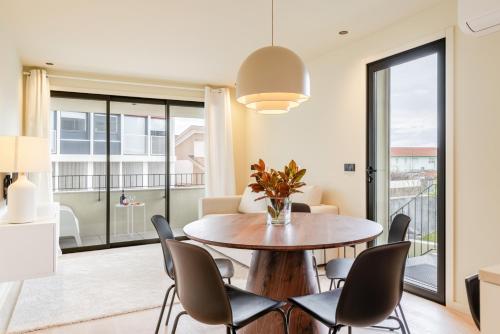 a dining room with a table and chairs at HostWise - Stylish Flat with Terrace & Garage in Porto