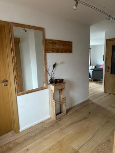 a living room with a mirror and a table at Haus Berger in Bayrischzell