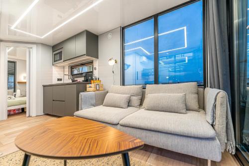 a living room with a couch and a table at The Homeboat Company Sant'Elmo-Cagliari in Cagliari