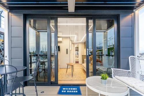 a room with glass doors and tables and chairs at The Homeboat Company Sant'Elmo-Cagliari in Cagliari