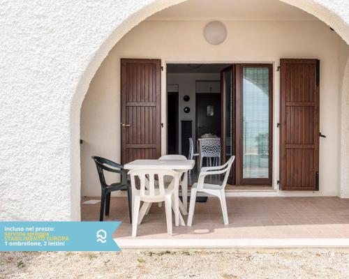 a white table and chairs on a patio at RS315 - Marcelli, bilocale in residence fronte mare in Marcelli