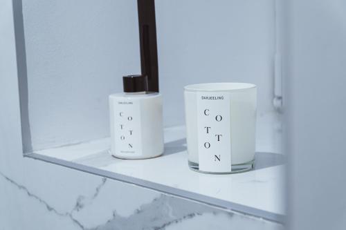 two white bottles on a shelf in a bathroom at Royal Central Apartments in Zagreb