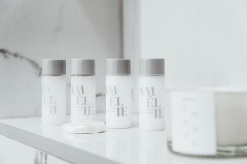 a row of white bottles on a shelf at Royal Central Apartments in Zagreb