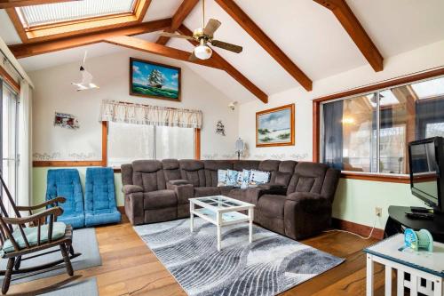 a living room with a couch and a table at Sunroom Central A C Large Fenced Yard in Yarmouth