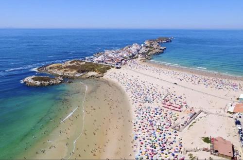 an overhead view of a beach with crowds of people at Modern City Center Apartment in Torres Vedras