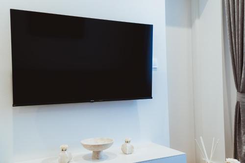a flat screen tv hanging on a white wall at Royal Central Apartments in Zagreb