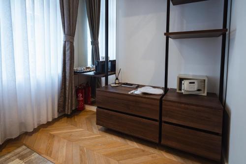 a room with a wooden dresser with a microwave on it at Royal Central Apartments in Zagreb