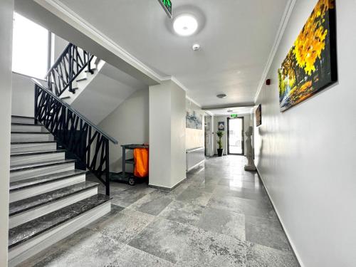 a hallway with stairs and a painting on the wall at Tempo Boutique in Buzau