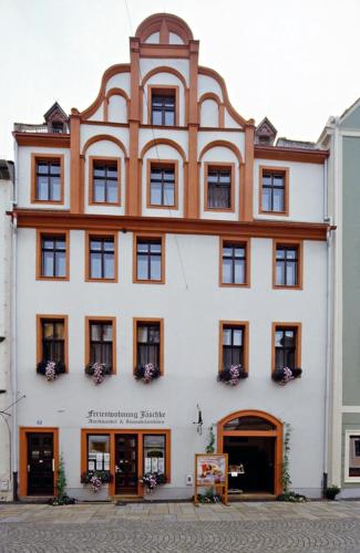 a large white building with brown trim at Ferienwohnungen Familie Jäschke in Görlitz