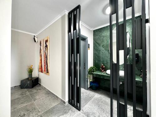 a hallway with a bathroom with a shower and a sink at Tempo Boutique in Buzau