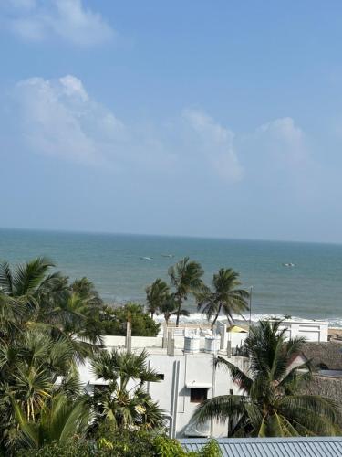 a view of the beach from the balcony of a resort at The Elite Beachview in Puducherry