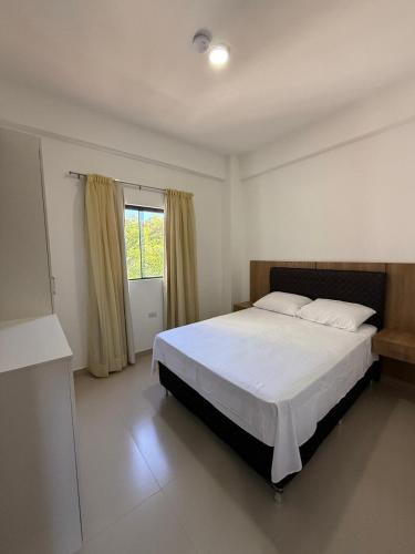 a bedroom with a large bed and a window at Departamento con vistas al rio in Encarnación