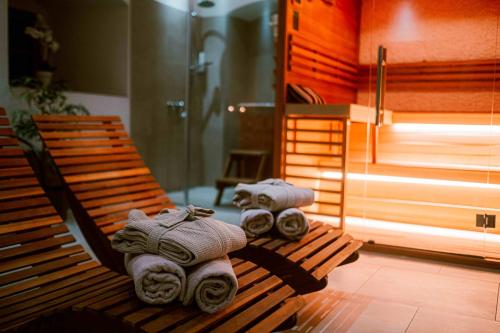 two rolls of towels sitting on a wooden bench at Resort Mlýn Karolínka in Vranov nad Dyjí