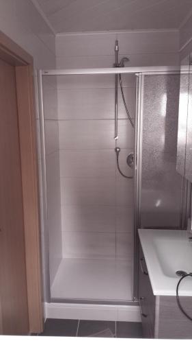 a shower stall in a bathroom with a sink at Ferienwohnung Jo Secco in Bruttig-Fankel