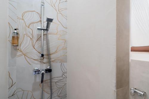 a shower in a bathroom with a wall at Luxury 12 in Tuglie