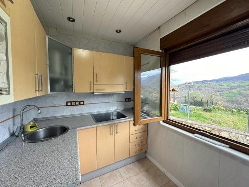 a kitchen with a sink and a window at Casa Verana en Asturias VV-3421-AS in Granda