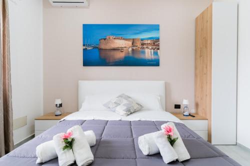 a bedroom with a bed with towels on it at Luxury 12 in Tuglie