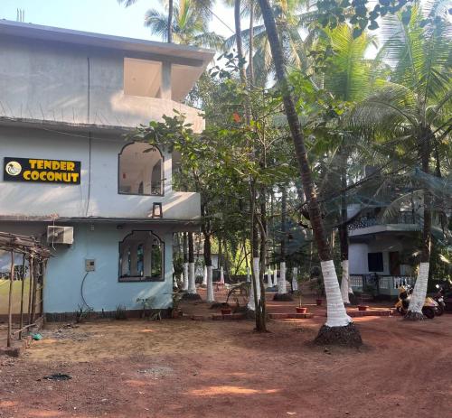 a building with a sign that reads turned coconut at Tender Coconut in Morjim