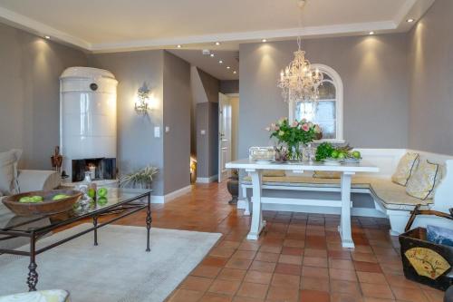 a living room with a table and a couch at Luxus Sönshörn 20 in Munkmarsch