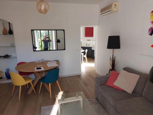 un salon avec une table et un canapé dans l'établissement Cannes centre avec parking et jardin, à Cannes
