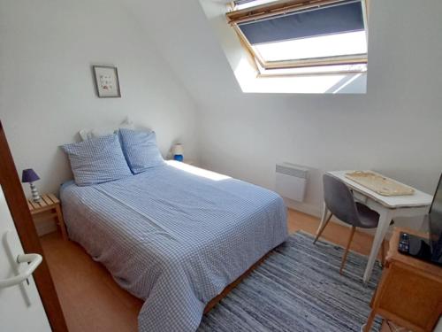 une chambre avec un lit, un bureau et une fenêtre dans l'établissement Petite maison proche plage à Penvins, idéale pour familles - FR-1-639-134, à Sarzeau