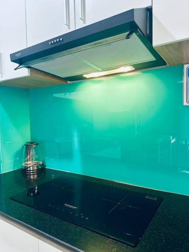 a kitchen with a green counter top with a stove at Trang Dream House Phan Rang in Kinh Dinh