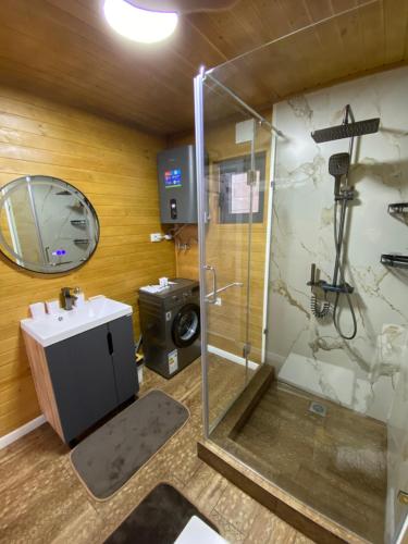 a bathroom with a shower and a sink at Open House in Orto-Say