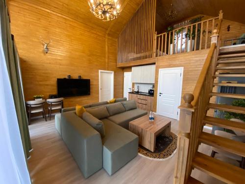 a living room with a couch and a table at Open House in Orto-Say