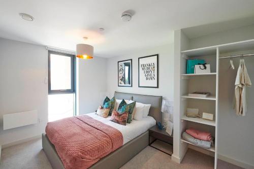 a bedroom with a bed with pillows on it at Duet Manchester in Manchester