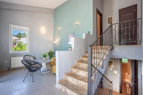 a staircase in a home with a table and a chair at Viorelis Sea View Villa in Kassandra
