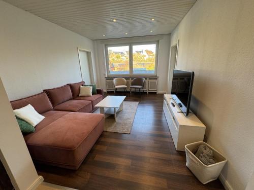 a living room with a couch and a tv at Ferienwohnung Arminius in Detmold
