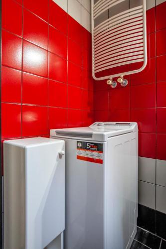 a red kitchen with a stove and a washer at Viorelis Sea View Villa in Kassandra