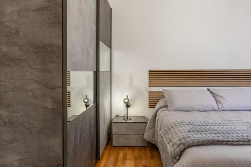 a bedroom with a large bed and a mirror at Il Cammino in San Quirico dʼOrcia