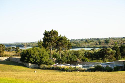 a view of a field with a river and trees at Podere Santa Chiara in Otranto