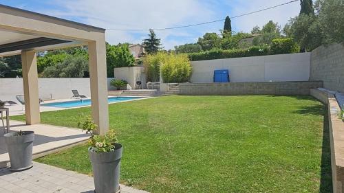 une cour avec une piscine et une maison dans l'établissement Villa Levant Piscine et Calme, à Poulx