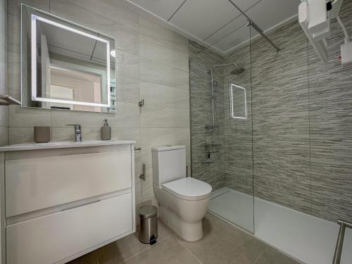 a bathroom with a toilet and a glass shower at Villamar 6 in San Pedro del Pinatar